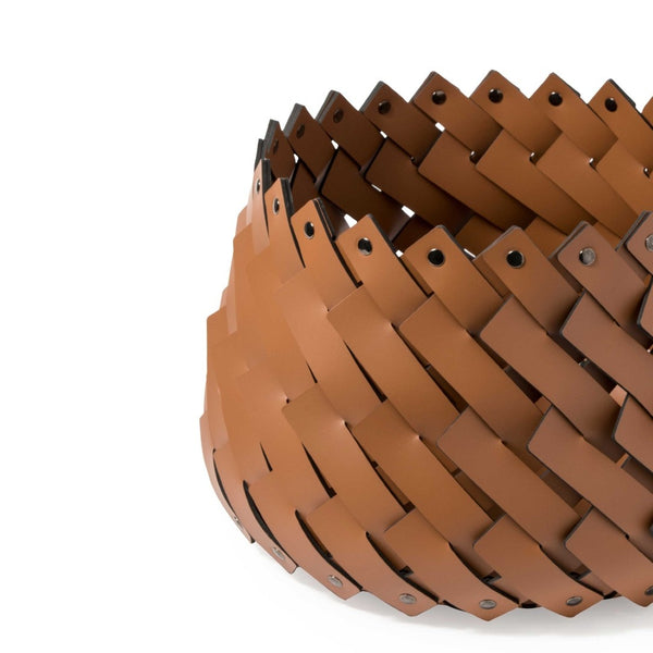Close-up of Almeria small round storage basket in camel brown regenerated leather by Pinetti, hand-woven and suitable for outdoor use