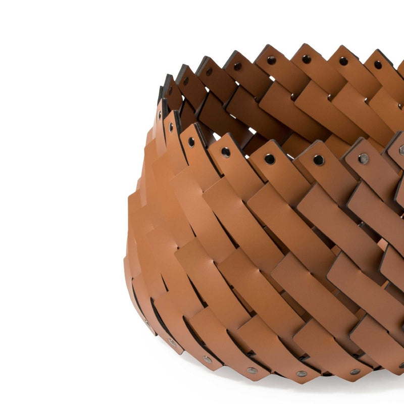 Close-up of Almeria small round storage basket in camel brown regenerated leather by Pinetti, hand-woven and suitable for outdoor use