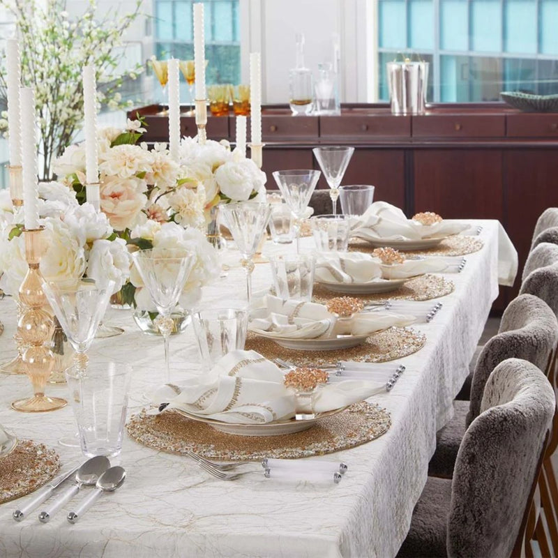 Kim Seybert Aster napkin ring in champagne colour on luxury elegant table setting.