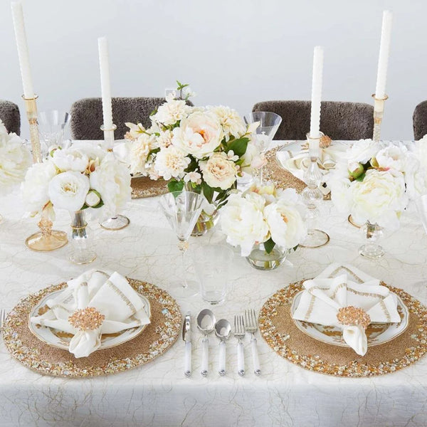 Champagne-colored Aster napkin ring on luxury floral tablescape.