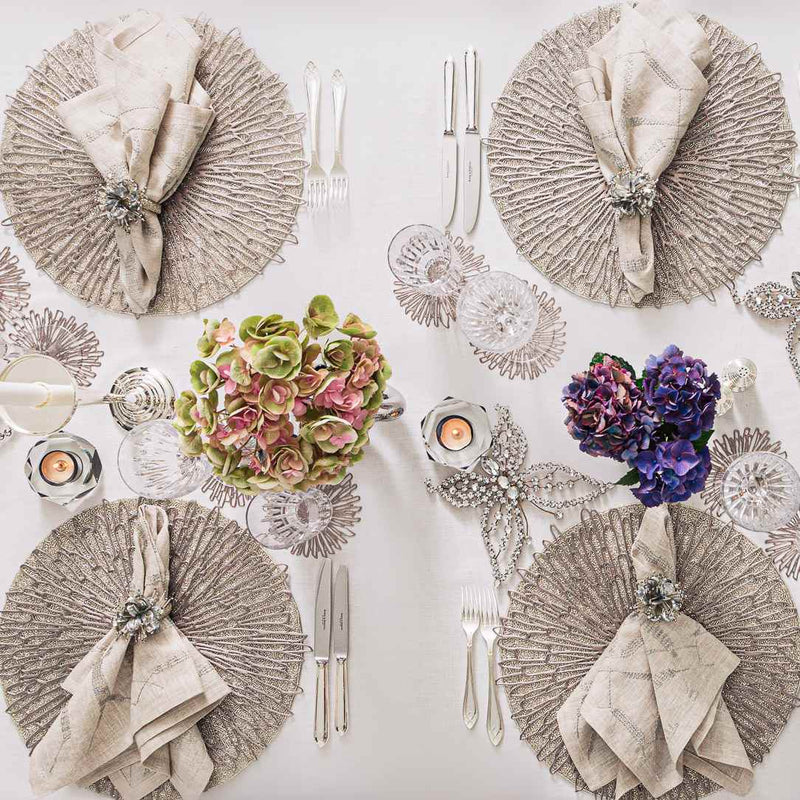 Gunmetal grey Bloom round vinyl placemat by Chilewich styled on luxurious grey tablescape.
