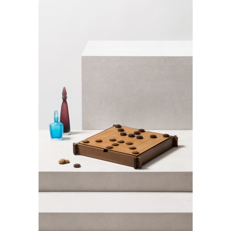 Lifestyle setting featuring the Structura Triple Game Box by Giobagnara on a white surface