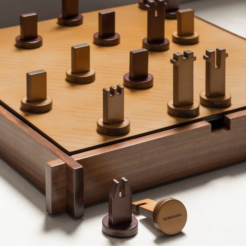 Detail of sculptural chess pieces on the Structura Triple Game Box by Giobagnara, crafted from brown and natural leather.