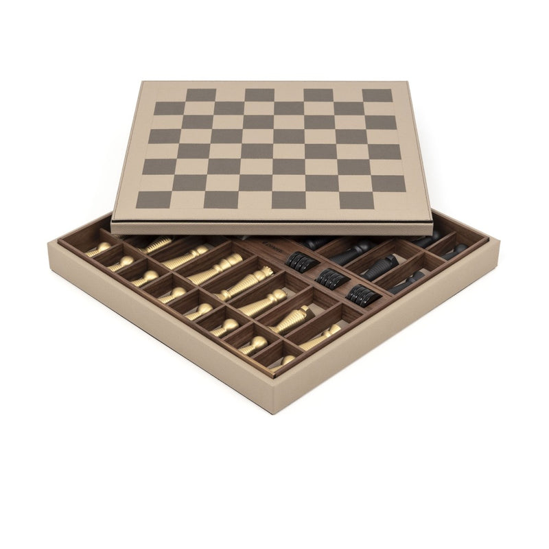 Open Pinetti chess and checkers board in grained taupe leather showing walnut interior storage with brass and black chess pieces.
