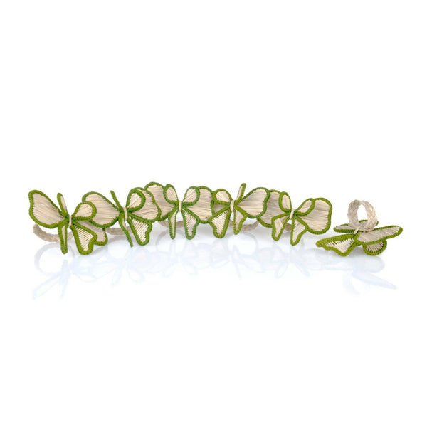 Green bow napkin rings handwoven in raffia, on white background.
