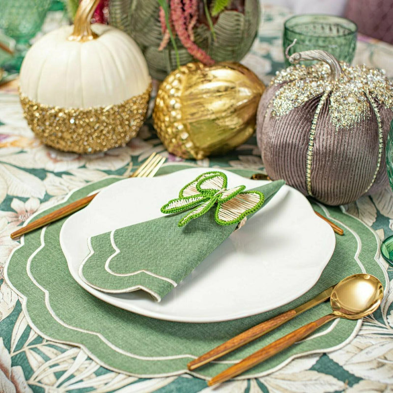 Green and beige bow napkin ringsby Roseberry Home styled on fall table setting.