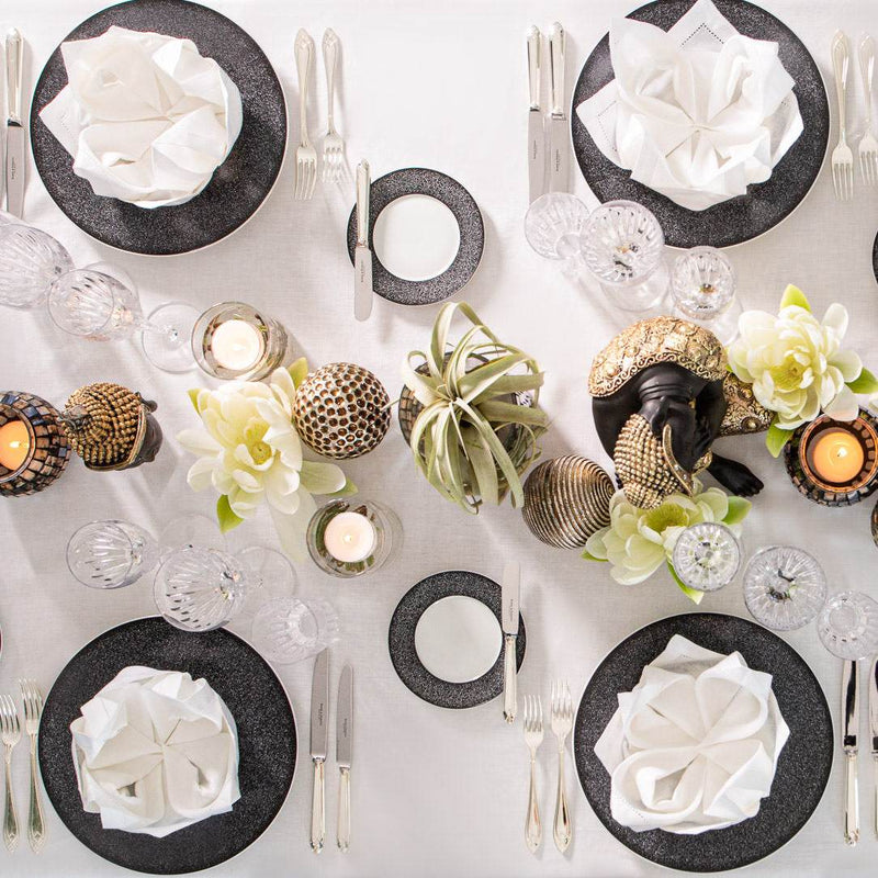 Close-up Overhead view of the Simply Asia themed table décor set by Amiramour featuring Buddhas, gold accents, mosaic candle holders, and white lotus flowers.