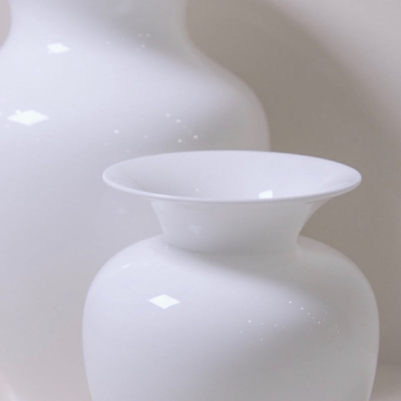 Two white vases on a light beige background