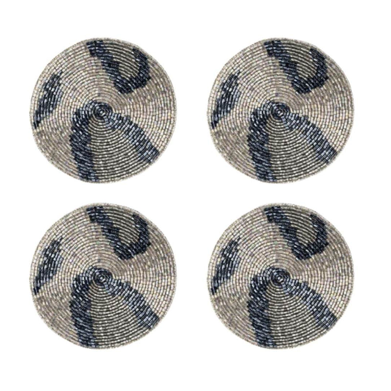 Four round beaded coasters with blue and silver patterns on a white background