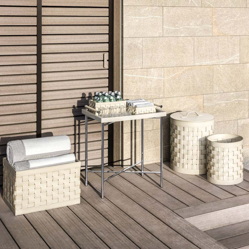 Outdoor setting with Barcellona rectangular low basket in ivory outdoor leather by Giobagnara x Riviere, handwoven design suitable for indoor and outdoor use
