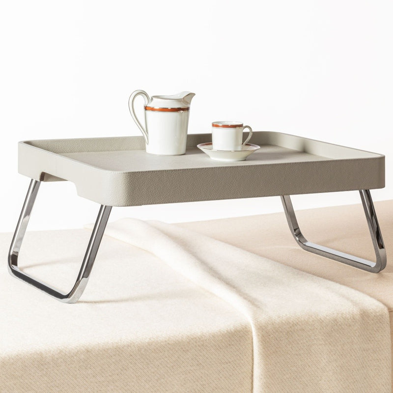 Bed Leather Folding Tray in Pelle Frau® by Giobagnara x Poltrona Frau with a pitcher and cup on a white background