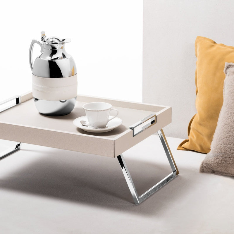 Bed Leather Folding Tray Vic by Giobagnara with a silver pitcher and white cup on a light surface.