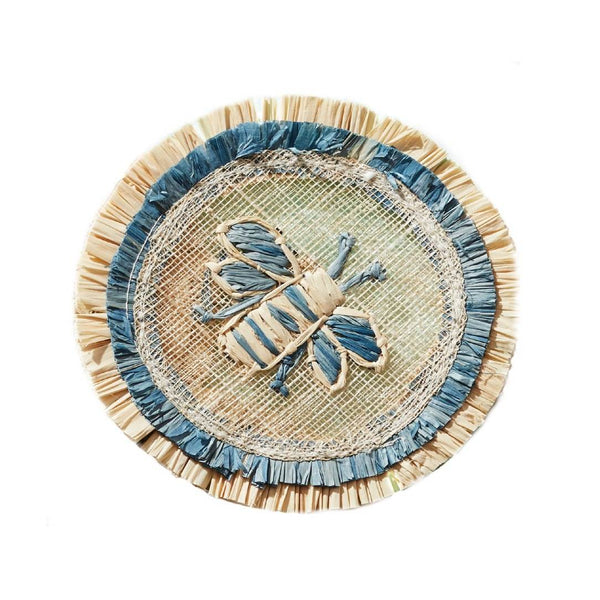Round woven straw coaster with blue and beige border featuring a bee on a white background