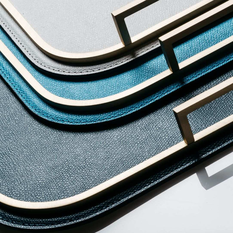Close-up ofBellini square leather tray with brass frame and handles by Giobagnara