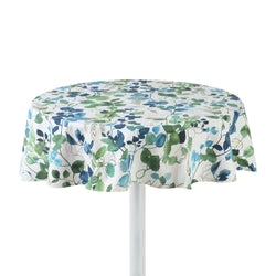 Round cotton tablecloth with a floral pattern in beige, blue, and green colors, featuring a sparrow motif, displayed on a table with a white base.