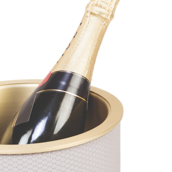 Champagne bottle with gold foil cap in a Bottle Cooler Positano in Bellagio leather by Giobagnara, insulated wine chiller with brass finish