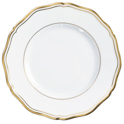 A round, white porcelain bread and butter plate with gold accents and a gold rim.