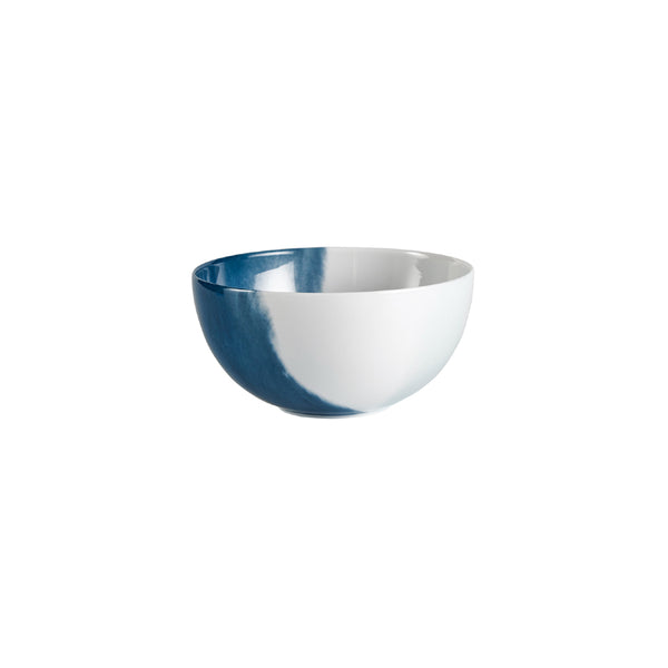 A round porcelain bowl with a blue and white design from the 'Abysses' collection by Raynaud.
