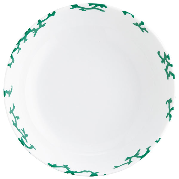 Round white plate with green coral patterns on a white background