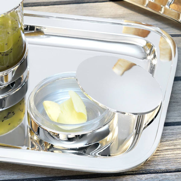 Silver tray with a Silver-plated butter dish with crystal base by Robbe & Berking on a wooden surface