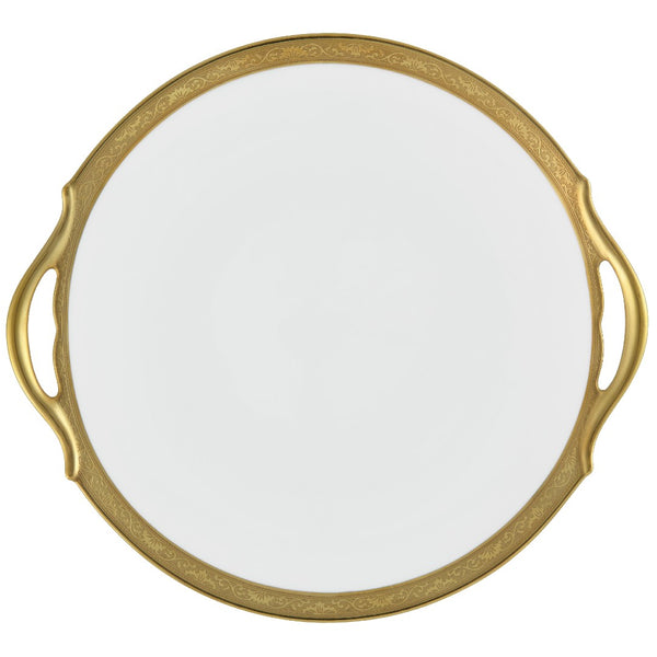 A white porcelain cake dish with a gold Renaissance style border, inlaid with gold details, and a handle on the side.