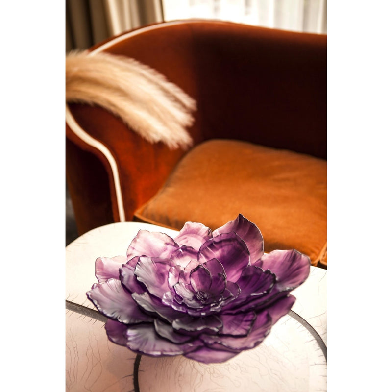 Purple glass bowl with a floral design on a table