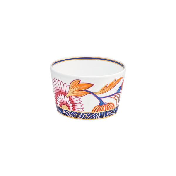 A multicolored porcelain candle pot with floral patterns and a blue border.
