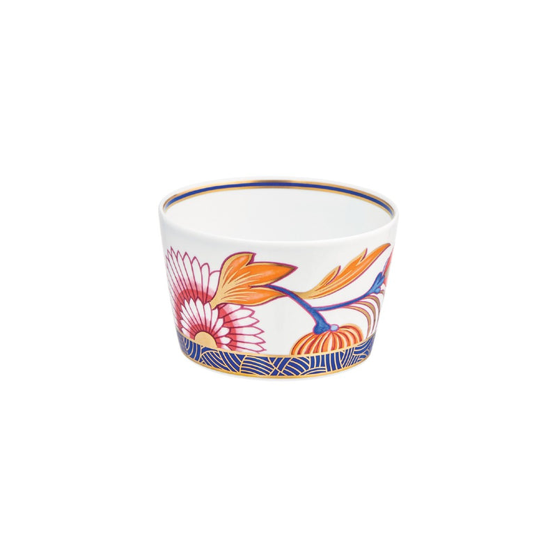 A multicolored porcelain candle pot with floral patterns and a blue border.