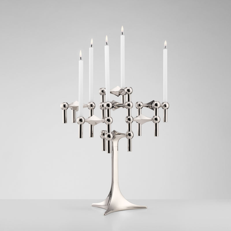 Silver candelabra with five candles on a gray background