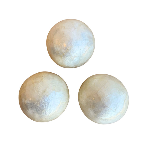 Three round ivory-colored capiz shell decorative balls are displayed against a white background. Each ball has a subtle, natural pattern and a glossy finish.
