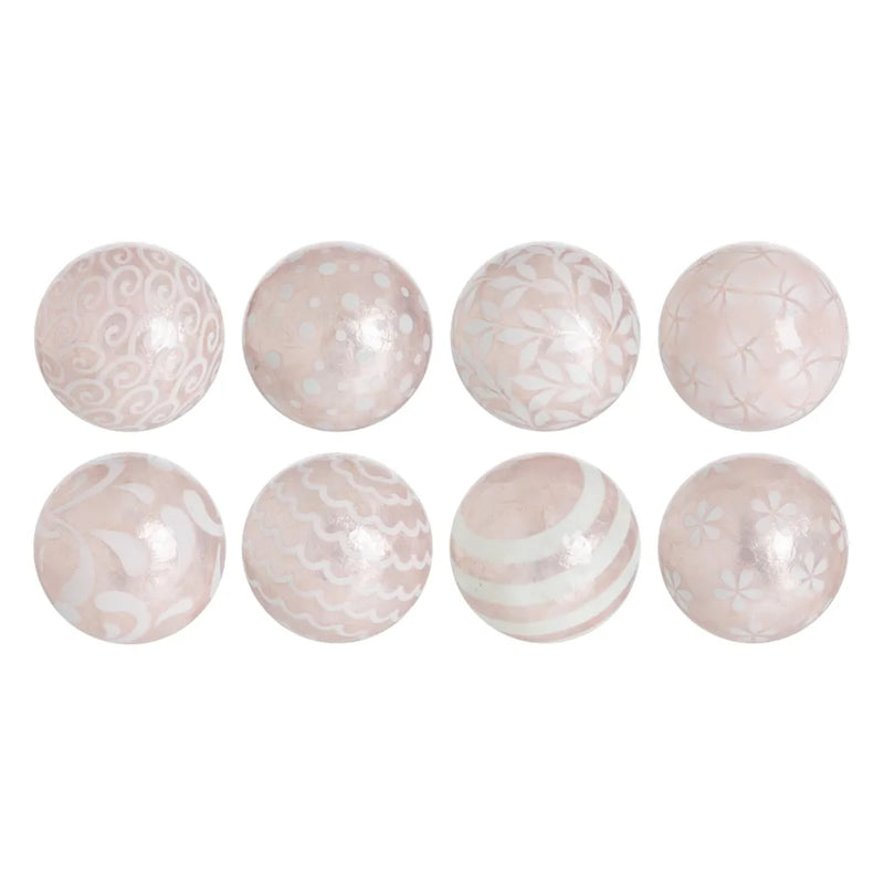 A set of round capiz shell decorative balls in pink with unique patterns, displayed on a plain background.