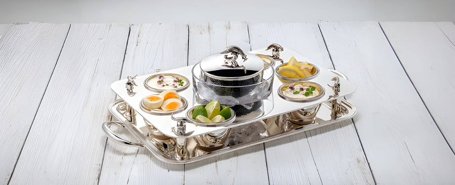 Caviar Silver tray set with various dishes on a white wooden surface