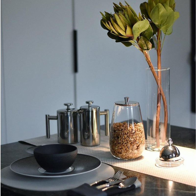 Styled brakfast with Borosilicate glass cereal muesli jar with airtight silver-plated lid by Greggio, luxury breakfast accessory from Amiramour’s Gourmet Breakfast Collection.