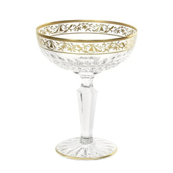 Viktoria crystal champagne coupe with diamond cuts and gold inlay by Cristallerie de Montbronn on a white background