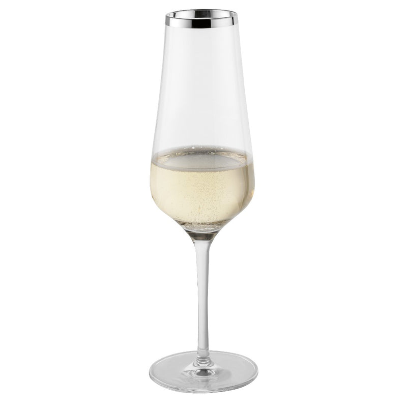 Clear champagne glass with white wine on a white background