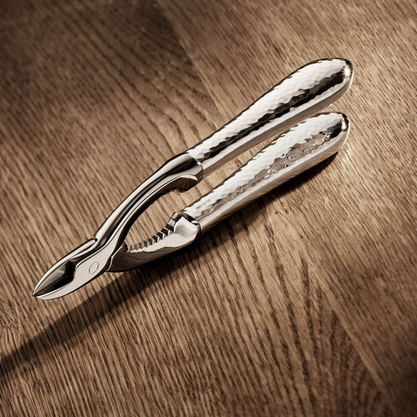 Champagne tongs Martelé silver-plated by Robbe & Berking on a wooden surface