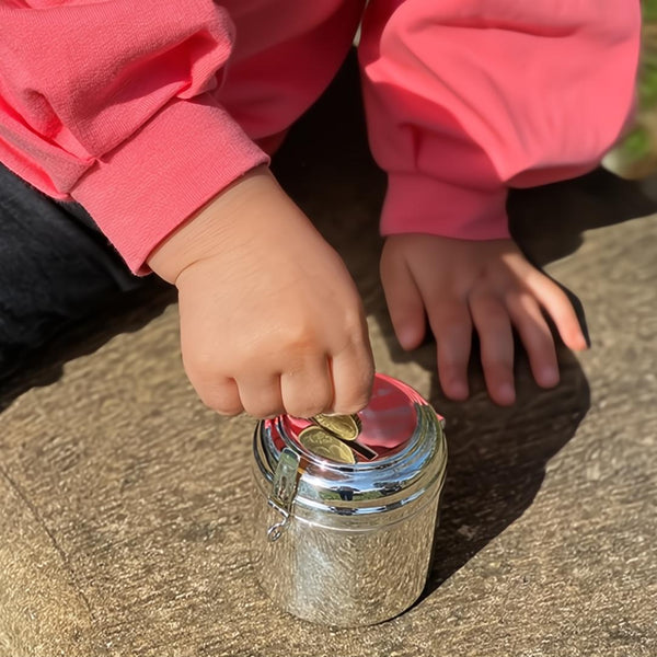 Styled Silver-plated children’s money bank box by Sonja Quandt, elegant round design with coin slot, luxury christening or birthday gift.