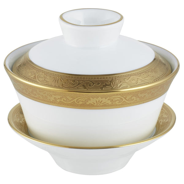 A white and gold colored Chinese tea cup with a gold rim and inlaid details, part of the Ambassador collection by Raynaud.