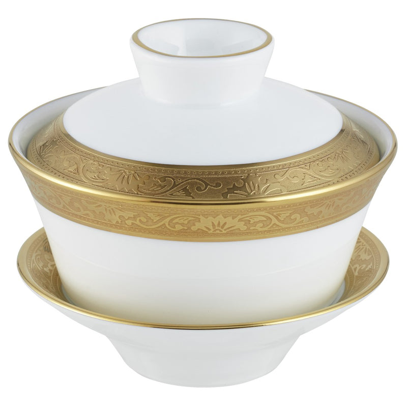 A white and gold colored Chinese tea cup with a gold rim and inlaid details, part of the Ambassador collection by Raynaud.