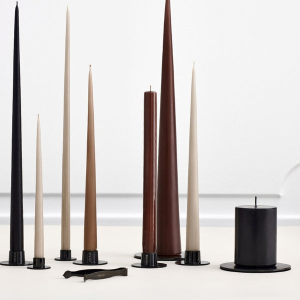 Set of various candles in different colors and shapes on a white background