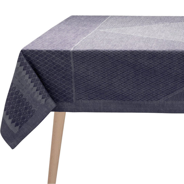 Navy blue geometric patterned tablecloth on a wooden table.
