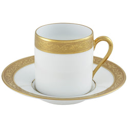 A white porcelain coffee cup with a gold border and inlaid gold details, part of the Ambassador Gold by Raynaud collection.