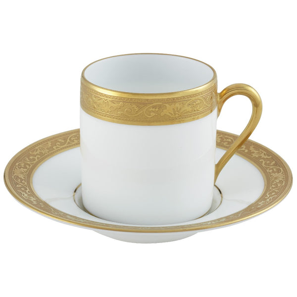 A white porcelain coffee cup with a gold border and inlaid gold details, part of the Ambassador Gold by Raynaud collection.
