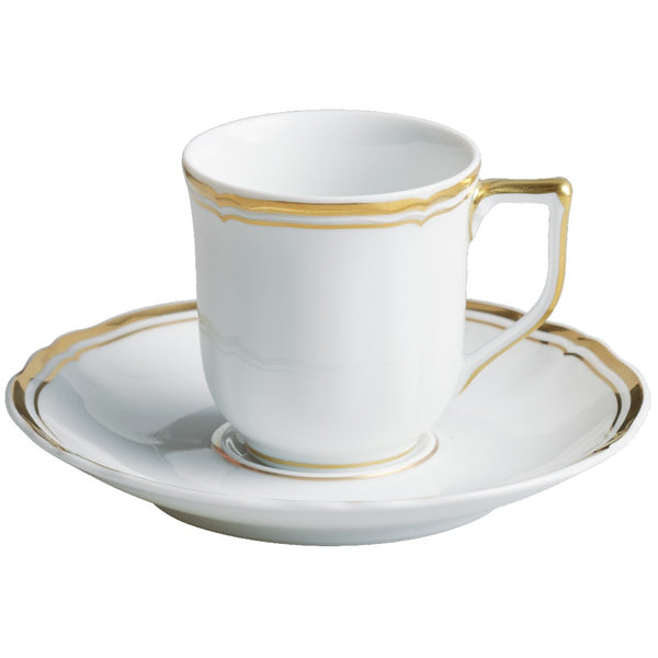 A white and gold porcelain coffee cup with a cup and saucer on a matching white and gold plate.