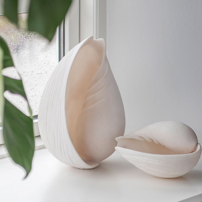 Large and small off-white faux conch shell decor for coastal luxury interiors