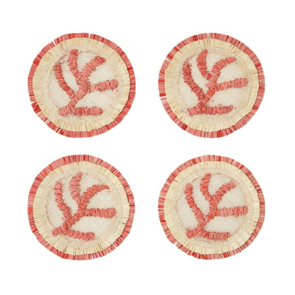 Four round coasters with coral designs on a white background