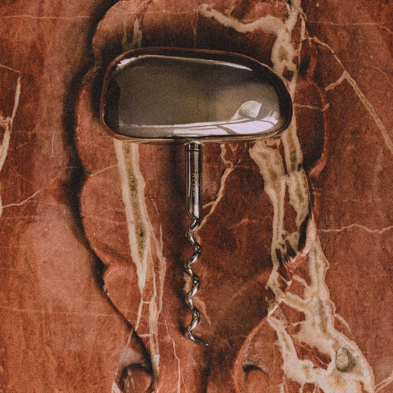 Corkscrew Maris in stainless steel by Kelly Wearstler x Giobagnara on a marble background 
