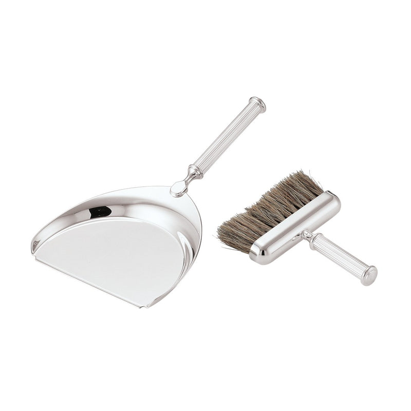 Polished metal dustpan and brush set on a white background