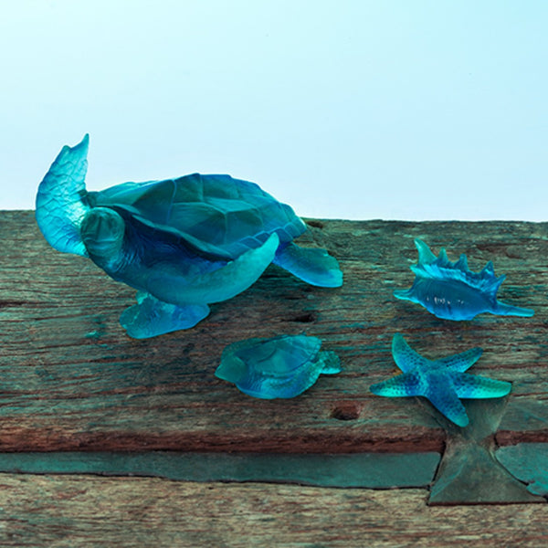 clue crystal sculptures featuring turtles and shells on a wooden stand