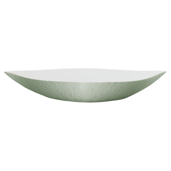 An elongated round white porcelain deep dish with a greenishceladon edge and interior, with a matte finish.